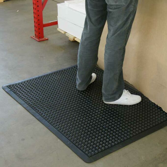 Black in color One-of-a-Kind Cushioned Mat Built for Comfort and Durability man standing
