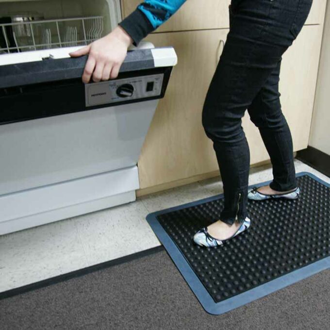 Blue in color One-of-a-Kind Cushioned Mat Built for Comfort and Durability person standing