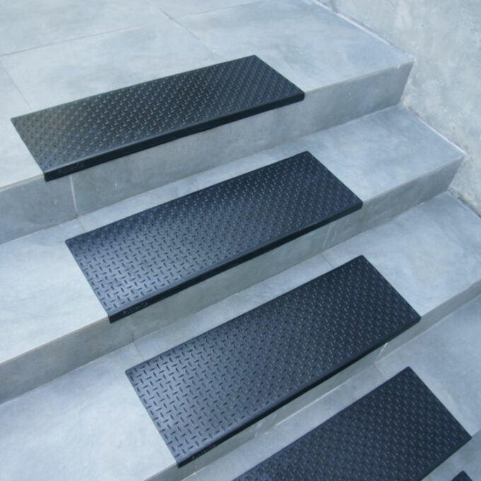Non-Skid, Affordable, Sturdy and Eco-Friendly Step Mats black in color placed on staircase
