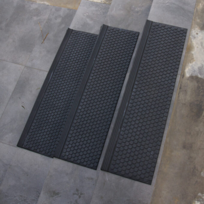 Black in color 6mm thick rubber steps to increase comfort, lessen impact, and withstand constant daily foot traffic.