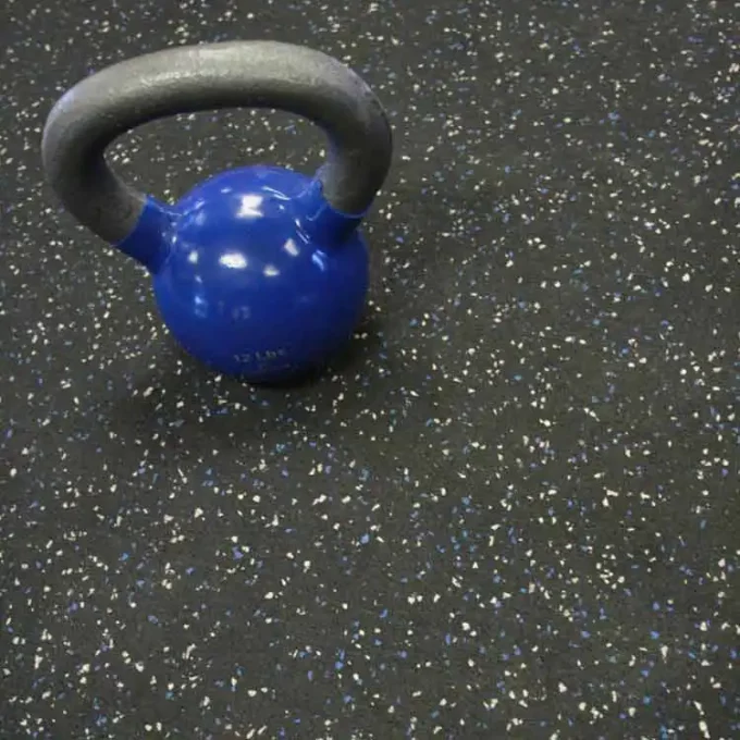 Blue Dot Recycled Rubber Roll placed on Gym Floor with Dumbell on top