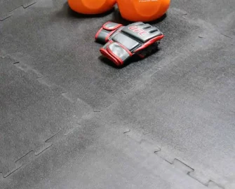 Black in color Easy-to-Install, Durable, Rubber Flooring Made from Reclaimed Rubber orange color dumbbells placed