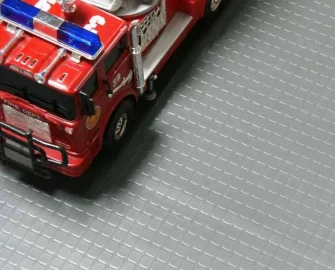 Block grip dark grey flooring placed under toy car