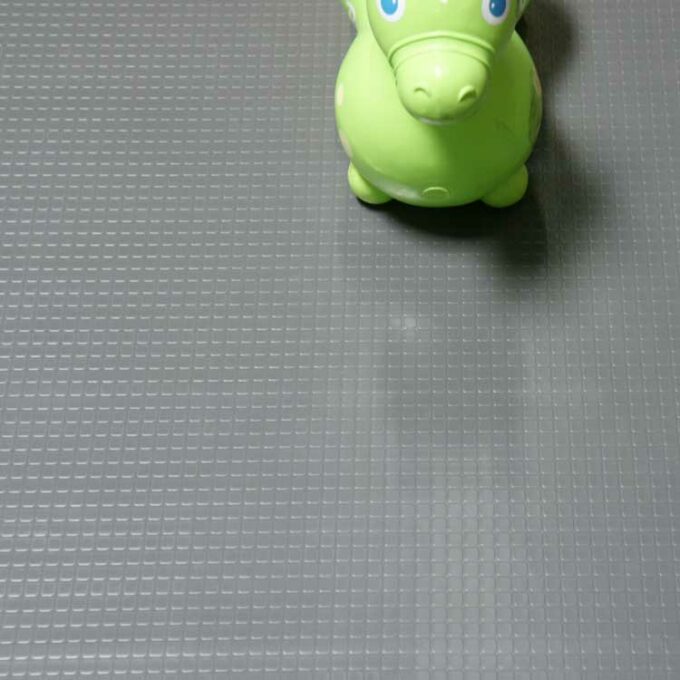 Block grip dark grey flooring placed under toy