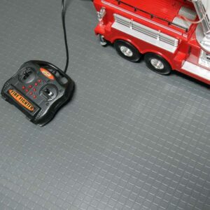 Square tile pattern underneath a remote powered toy fire truck