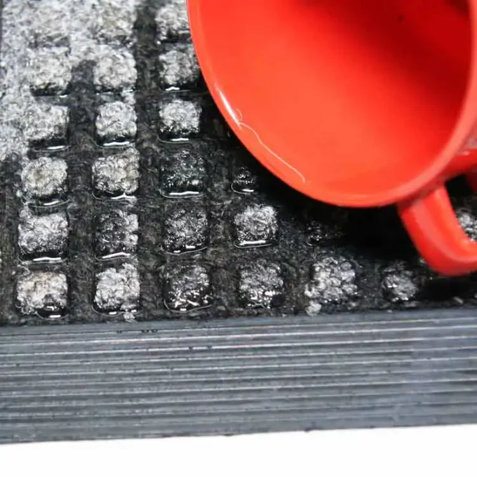 Charcoal color mat water spilled from red cup to show mat dries quickly