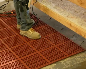 Red color Rubber Drainage Mat, A Great Slip-Resistant Surface man standing