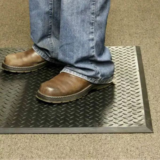 Black Color Textured Industrial Mats with Durability and Slip-Resistance man standing