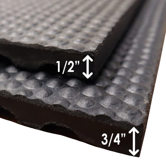 Two close up horse stall mats on top of each other