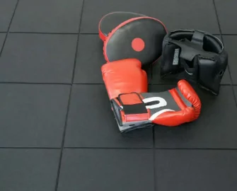 Interlocking Cushioned Flooring Tiles, Perfect for Gyms or Garages red gloves kept on it