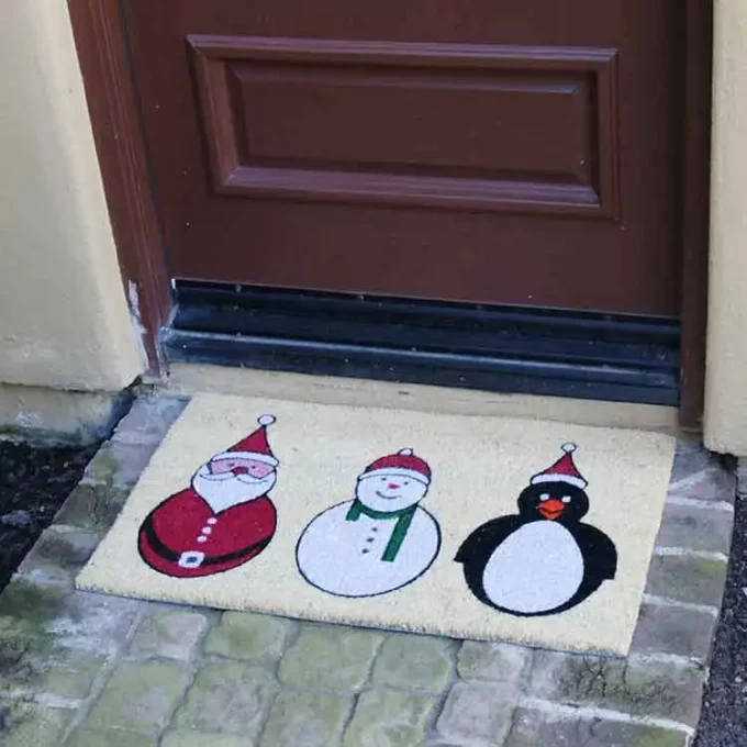Santa, Snowman, and Penguin displayed from left to right in front of door entrance