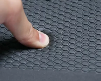 Black in color Grease-Resistant Anti-Slip Mat with a 3/4" Thick Comfort Layer pressed by thumb