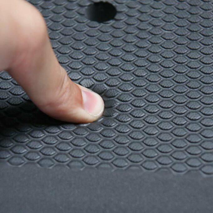 Black in color Grease-Resistant Anti-Slip Mat with a 3/4" Thick Comfort Layer pressed by thumb