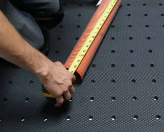 Black in color Grease-Resistant Anti-Slip Mat with a 3/4" Thick Comfort Layer taking measurements
