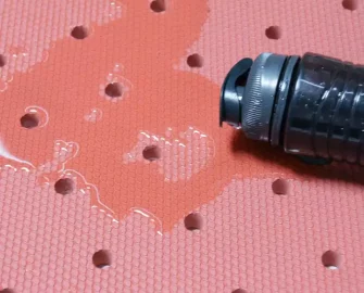 Red in color Grease-Resistant Anti-Slip Mat with a 3/4" Thick Comfort Layer water spilled from bottle drained