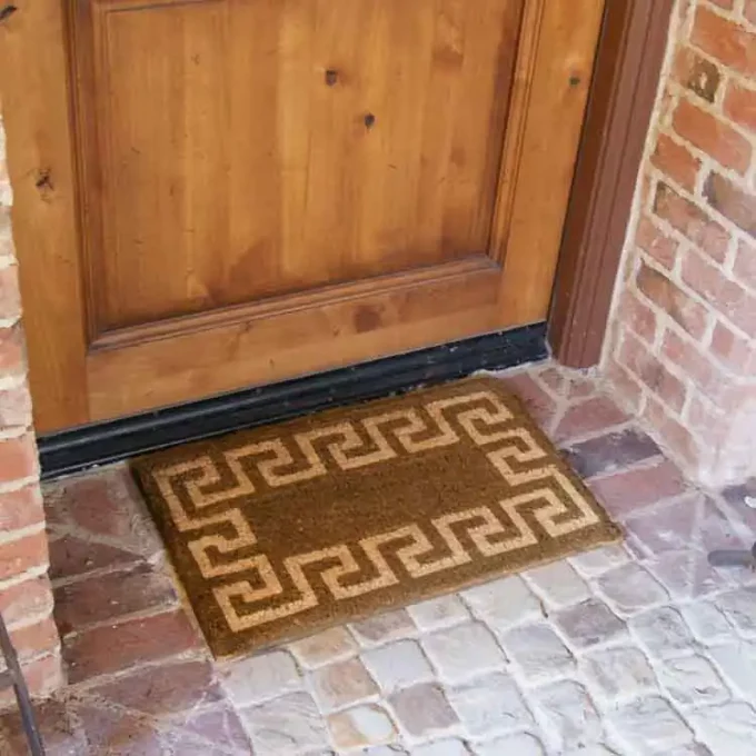 The doormat in brown & tan color combination design around the border at front door