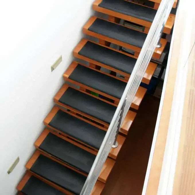Black color Anti-Slip Stair Tread Mats Provide Foothold in Wet or Dry Conditions placed on staircase