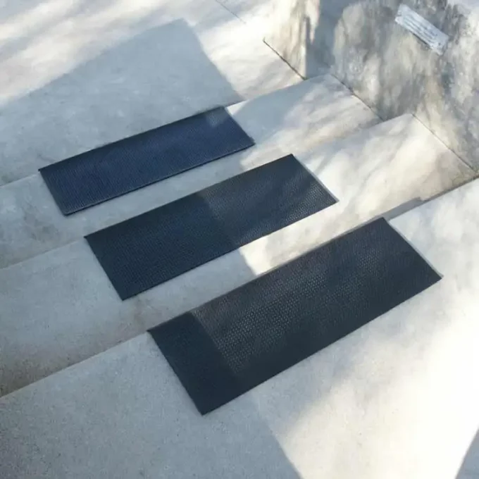 Black color Anti-Slip Stair Tread Mats Provide Foothold in Wet or Dry Conditions placed on staircase