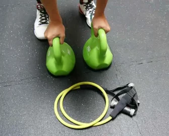 Person using black zcycle tile on floor for exercise