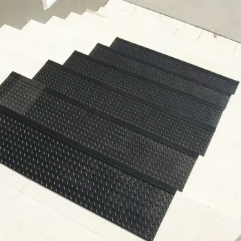 “Diamond-Plate” textured black in color step mats placed on staircase