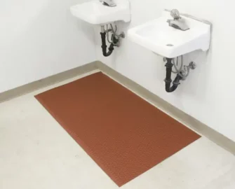 Red mat displayed in a bathroom