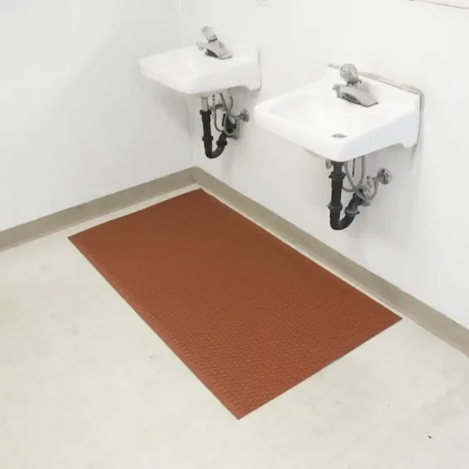 Red mat displayed in a bathroom