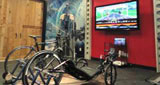 Bikes on the left, rubber flooring on the right and a TV in between