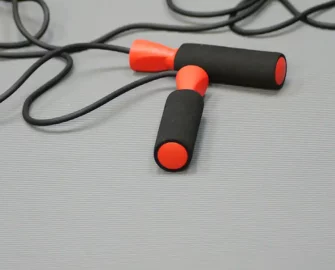Wired red training equipment on top of a fine gray rib mat