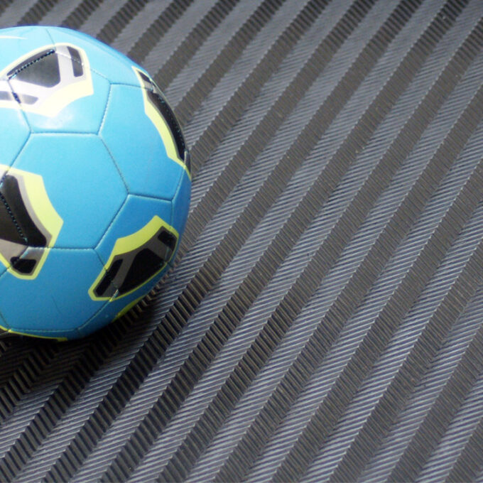 Black in color Fishbone-Pattern textured surface enhances traction blue ball placed on it