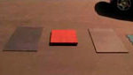 Four different rubber tiles splayed out one red one black one brown