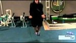 Man doing jump ropes on green rubber mats