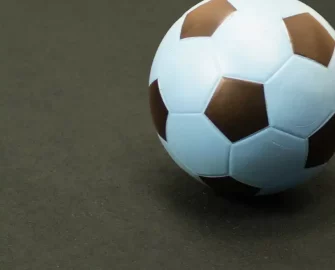 Soccerball on top of a recycled black rolls mat