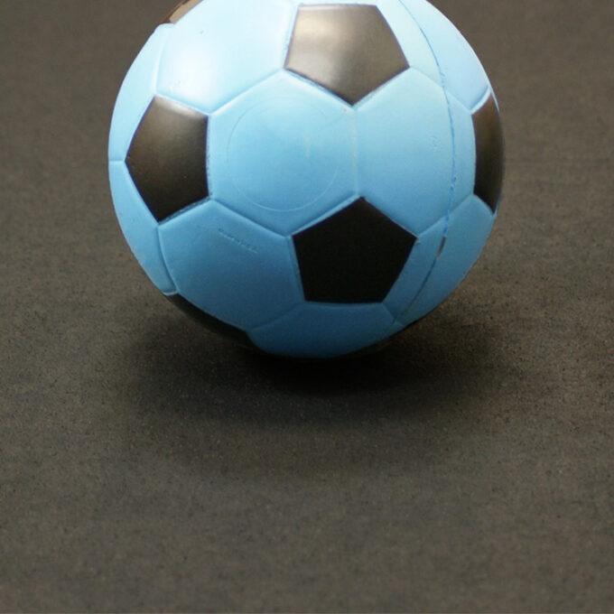 Soccerball on top of a recycled black rolls mat