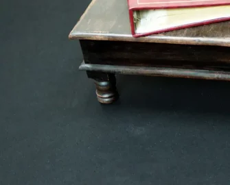 Table and book on the right on top of a recycled rolls black mat