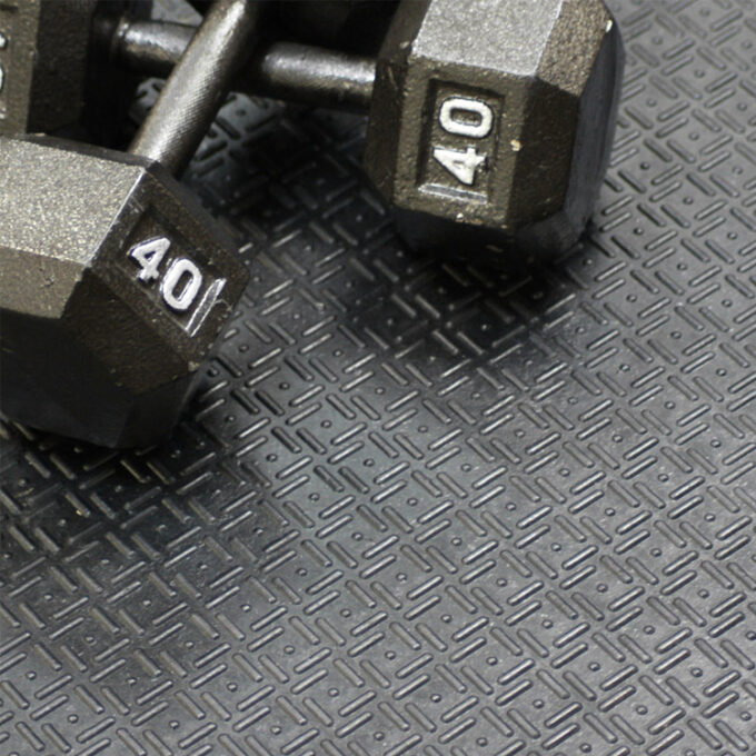 Black in color Thick Rubber Mat Designed for Impact-Heavy Applications dumbells kept