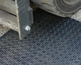 Black in color Thick Rubber Mat Designed for Impact-Heavy Applications heavy machinery kept