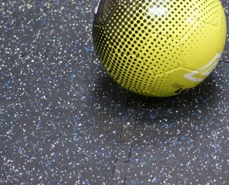 Speckled blue tile with a yellow ball on the right side