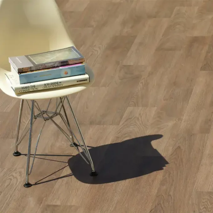 Do It Yourself Rolled PVC Flooring in nutmeg finish chair with books on it is placed on it