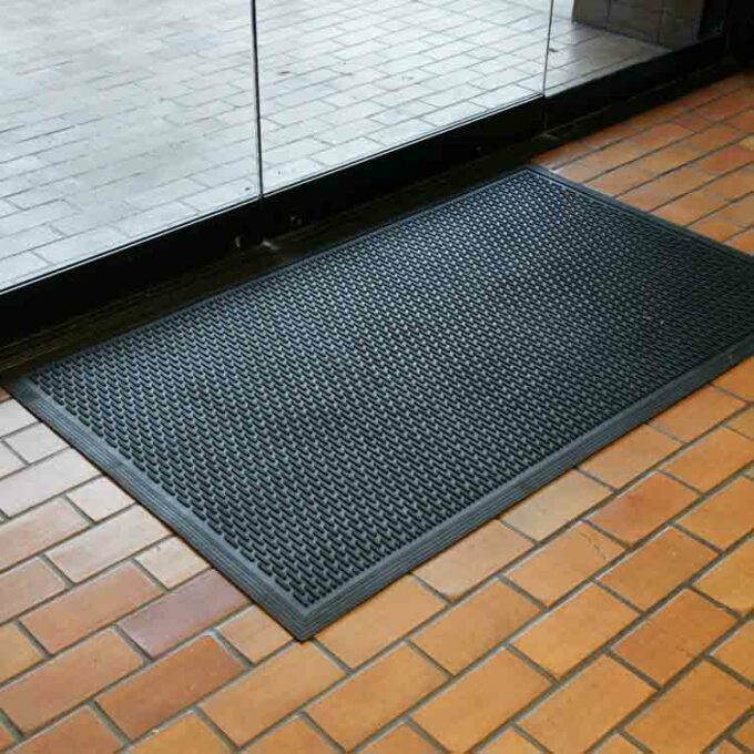 Black color Ultra-Durable and Economical Rubber Doormat placed on floor