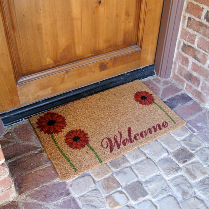 field of red daisy doormat in front of door