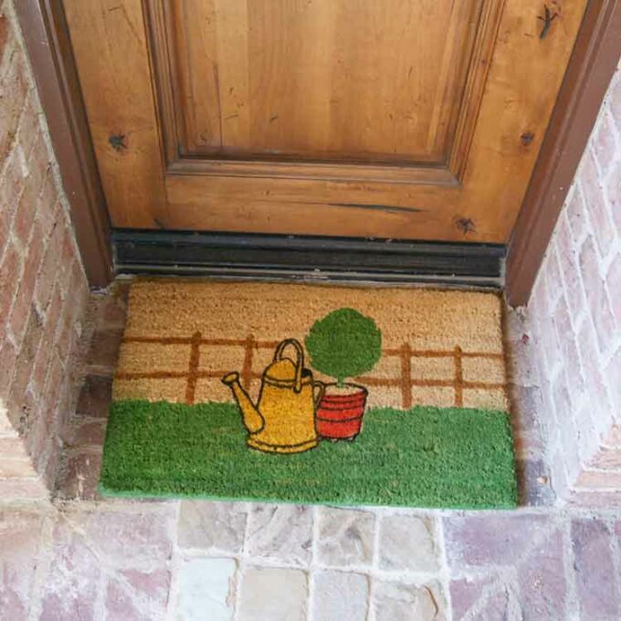 Eco-Friendly Coir Mat with a picture of garden fence & plant
