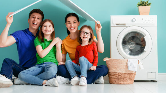 Dad, Mom And Children Sit Next to Washing Machine and Happy